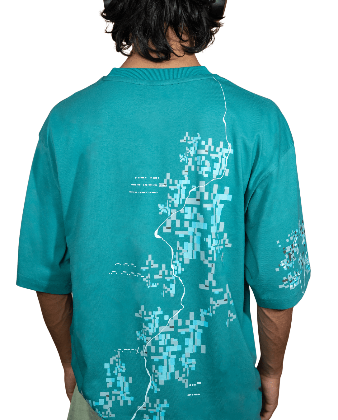 Back view of green oversized cotton t-shirt showing fragmented print extending from front - VYVHR