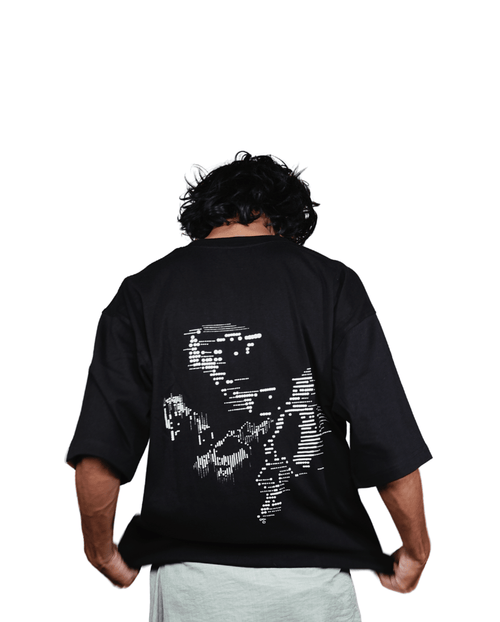 Back view of black oversized cotton t-shirt with structured linework design - VYVHR